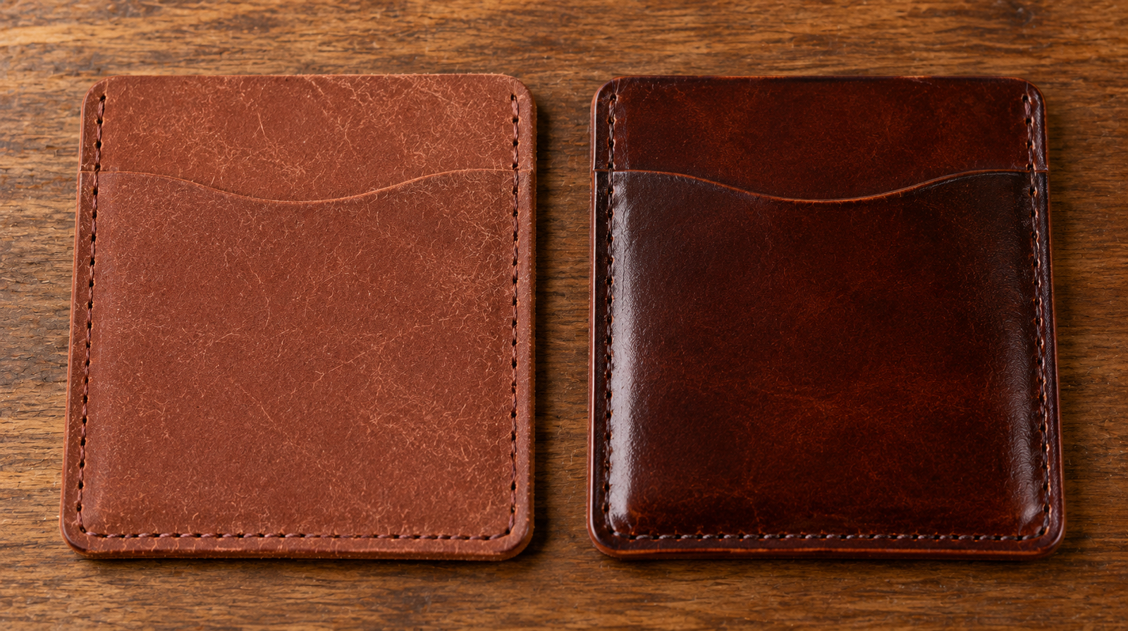 Two identical leather card wallets side by side on a dark wood surface showing a new Pueblo wallet on the left with a lighter matte scratched surface and an aged Pueblo wallet on the right that is noticeably darker, smoother, and glossier from handling
